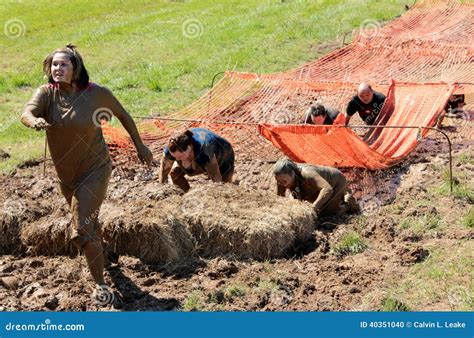 People Running Through The Mud While Competing In A Mud Run Editorial ...