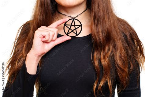 Lady in black showing a large pentagram necklace Stock Photo | Adobe Stock