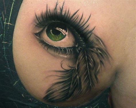 Green eye with feather tattoo - Tattooimages.biz