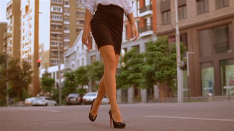 Close up female legs walking along the sidewalk. unrecognizable ...