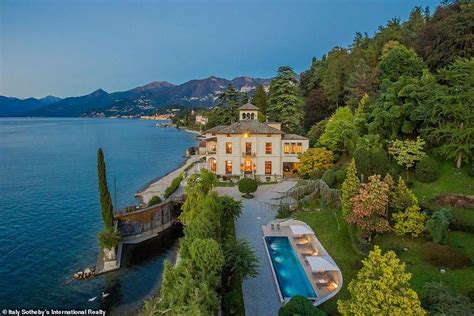 an aerial view of a mansion with a swimming pool in the foreground and ...