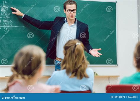 Teacher Standing With Notebook In Classroom Royalty-Free Stock Photography | CartoonDealer.com ...