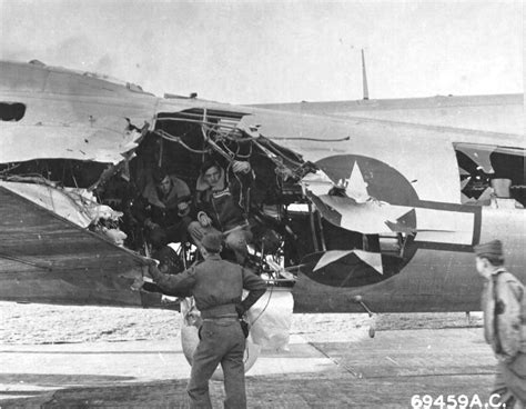 Crews examine flak damage to B-17G Fortress at RAF Bassingbourn ...