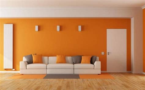 an orange living room with white couches and pillows