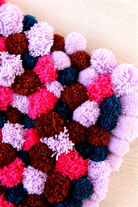 DIY Pom Pom Rug | FaveCrafts.com