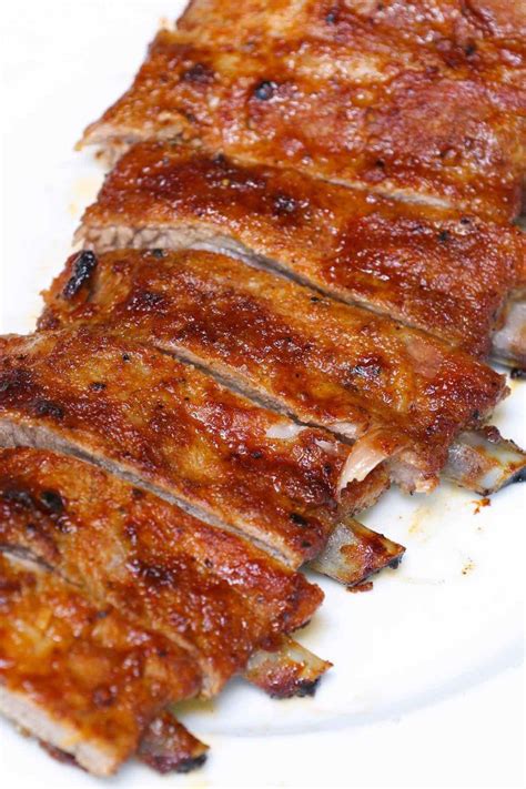 Perfectly cooked spare ribs with the bone sticking out a half-inch from ...