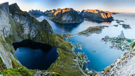 Sunset aerial view from Reinebringen ridge on mountains and village of ...