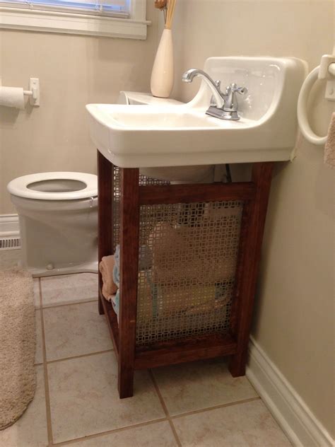 Solution for old wall mounted sink that is super hard to replace: pine boards and vent grate ...