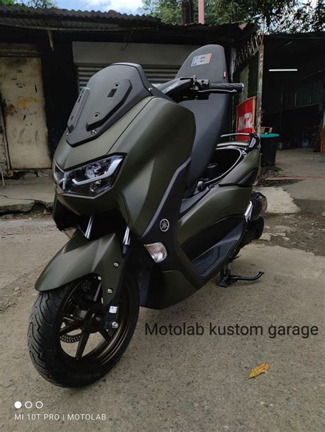 Matte Green Motorcycle Parked in Front of Motofab Kustom Garage