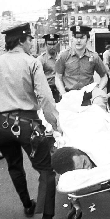 Jerome Johnson, believed to be the assailant who shot Joseph Colombo, is being carried by police ...