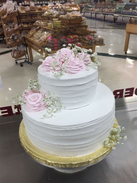 a large white cake with pink flowers on top