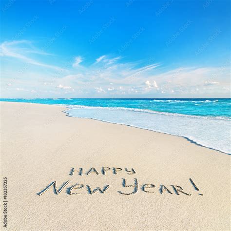 Happy New Year caption at tropical ocean beach against waves Stock ...