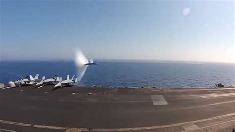 U.S. Navy Jet Breaks Speed Of Sound Flying Past Aircraft Carrier At Supersonic Speed