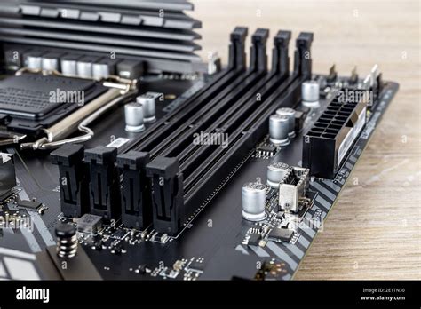 Four slots for ddr4 ram memory modules on a modern black pc motherboard. Computer mainboard ...