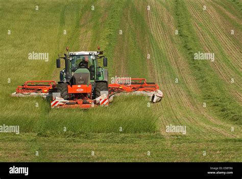 Tractor pulling grass-cutter cutting grass for making hay Stock Photo, Royalty Free Image ...