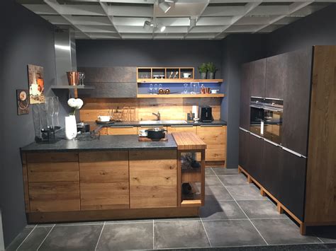 a modern kitchen with wooden cabinets and black counter tops, along ...