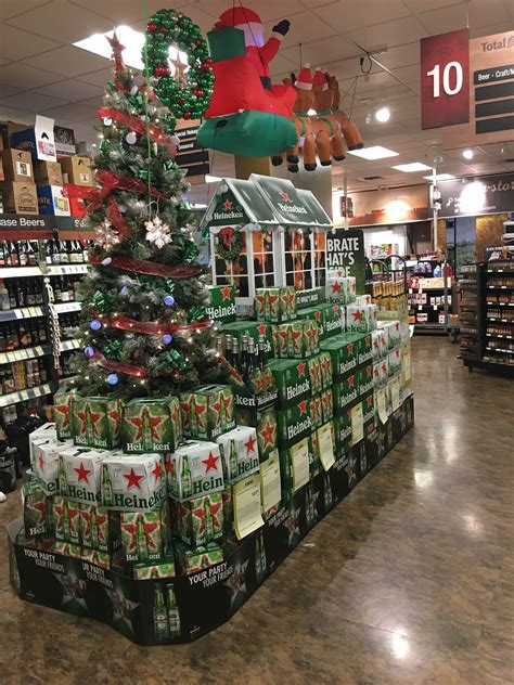 a christmas tree is in the middle of a grocery store with many wrapped ...