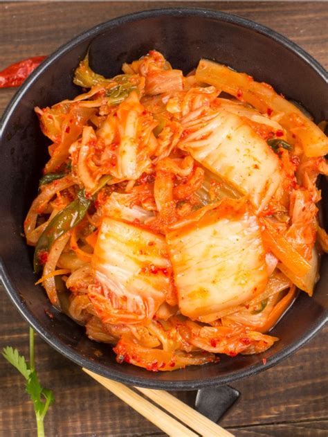 cabbage and carrots in a skillet with chopsticks