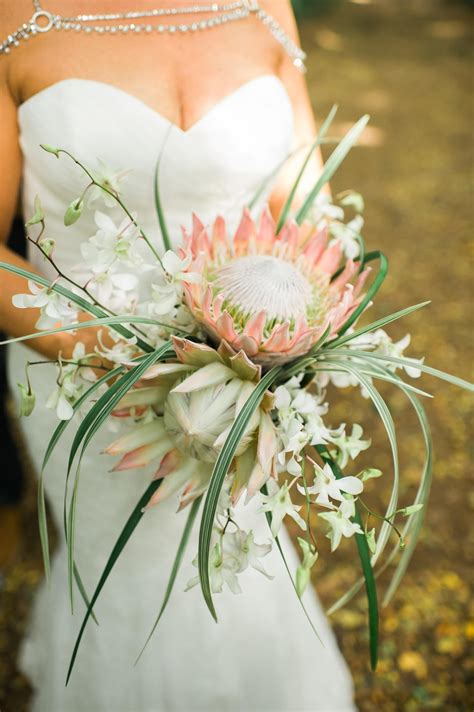 Bridal bouquet, king protea, white orchids, fronds, diamond body jewelry, tropical fl… | Orchid ...