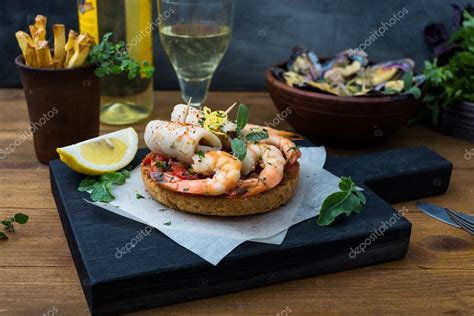 Spanish Tapas with seafood: shrimp and squid Stock Photo by ©kopachinsky 120599758