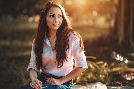 Royalty-Free photo: Woman wearing brown floral dress sitting beside ...