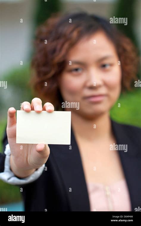 Business woman holding a name card Stock Photo - Alamy