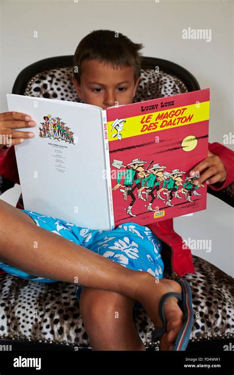 Boy reading comics Stock Photo - Alamy