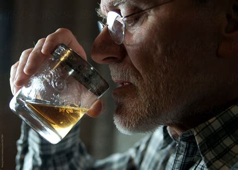 "Old Man Drinking Whiskey" by Stocksy Contributor "Marija Anicic" - Stocksy