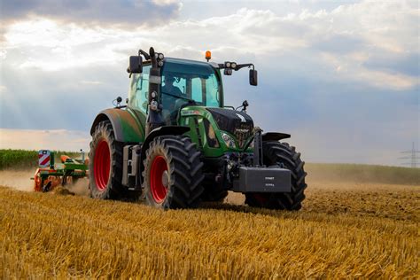 Green Tractor Plowing The Fields on Focus Photography · Free Stock Photo