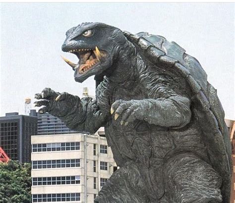 a large godzilla statue in the middle of a city