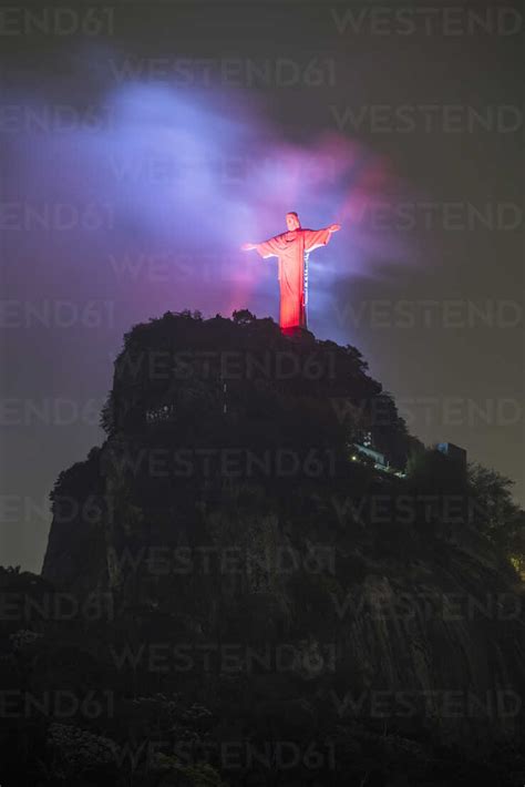 Christ the Redeemer statue with red lights during early night ...