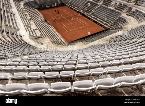 Rome Tennis Stadium. Two tennis players practice with their trainer in ...