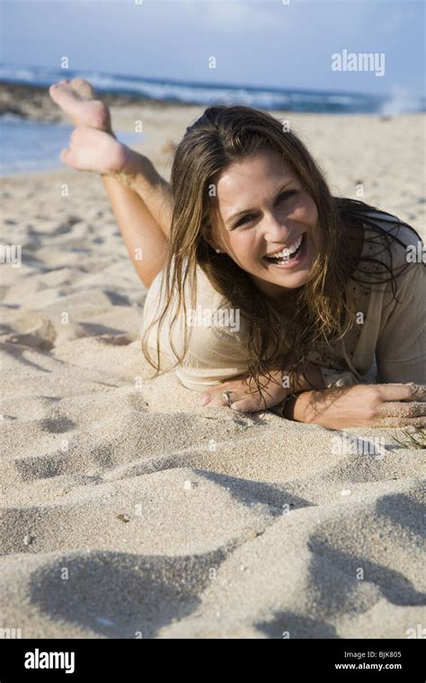 Woman on beach laughing Stock Photo - Alamy