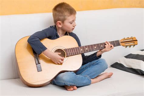 A Young Boy is Playing Guitar Stock Photo - Image of guitar, indoor ...