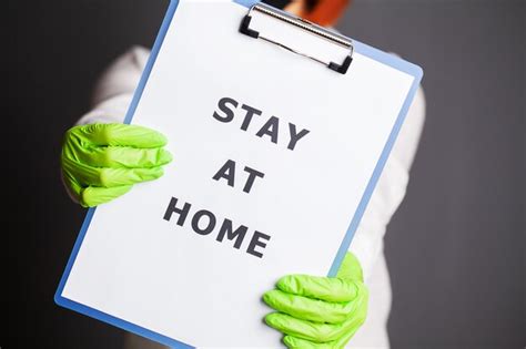 Premium Photo | Closeup of woman holding blank with inscription stay at home calling for stop ...