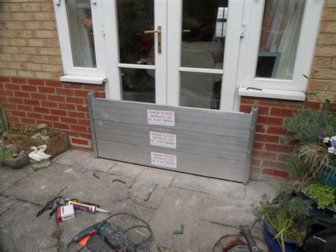 A flood barrier installation to a set of French doors. Flood barriers ...