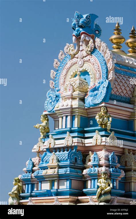 Indian gopuram temple architecture against a bright blue sky, in the ...