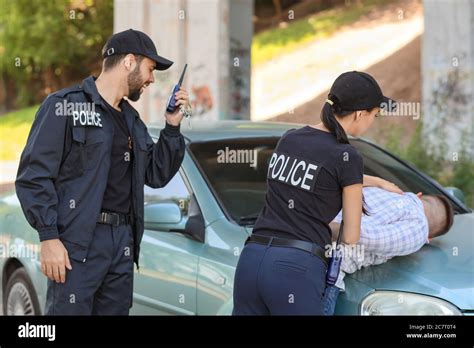 Police officers arresting criminal outdoors Stock Photo - Alamy