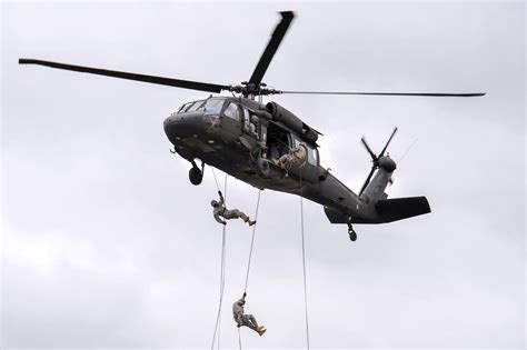 U.S. troops rappel from a UH-60 Black Hawk helicopter during an air ...