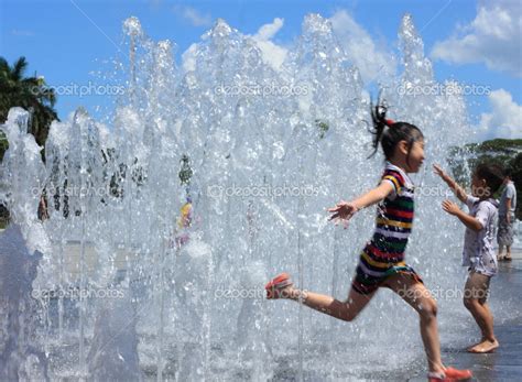 Kids Playing in water fountains — Stock Photo © kingqjl #12582201