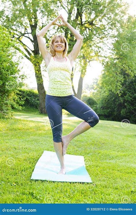 Woman in yoga tree pose stock photo. Image of green, exercise - 32020712