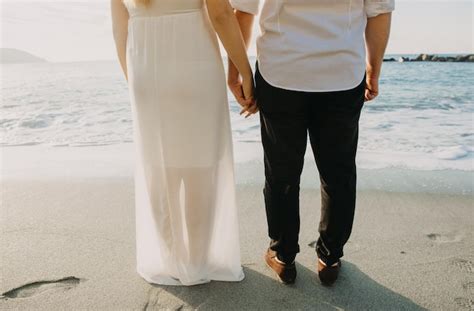 Premium Photo | A couple holding hands on the beach