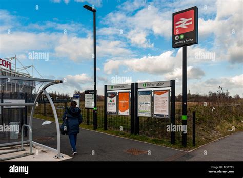 Woman walking to the Coventry Arena train station in Coventry, UK, with ...