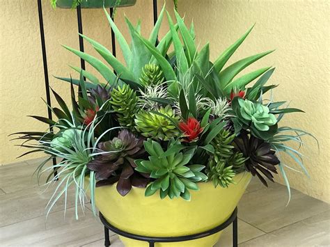 A dense assortment of artificial succulents makes for a beautiful planting on a Florida ...
