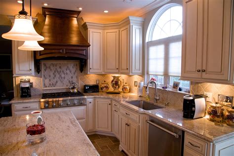 Kashmir Gold granite countertops with natural stone backsplash tile and ...