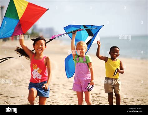 Children age 6 flying kites on the beach with mixed ethnic kids Stock ...