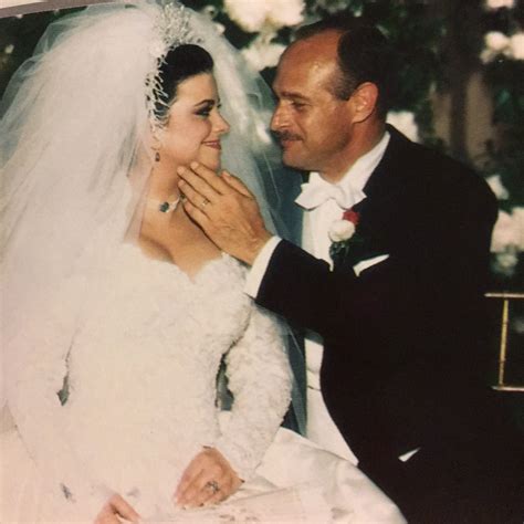 an old photo of a bride and groom smiling at each other in their wedding day