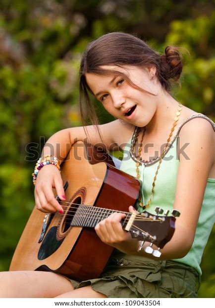 Young Girl Playing Guitar Singing Outdoors Stock Photo (Edit Now) 109043504