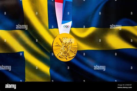 April 22, 2021 Beijing, China. Olympic gold medal against the background of the flag of Sweden ...