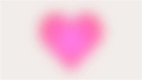 a blurry pink heart on a white background